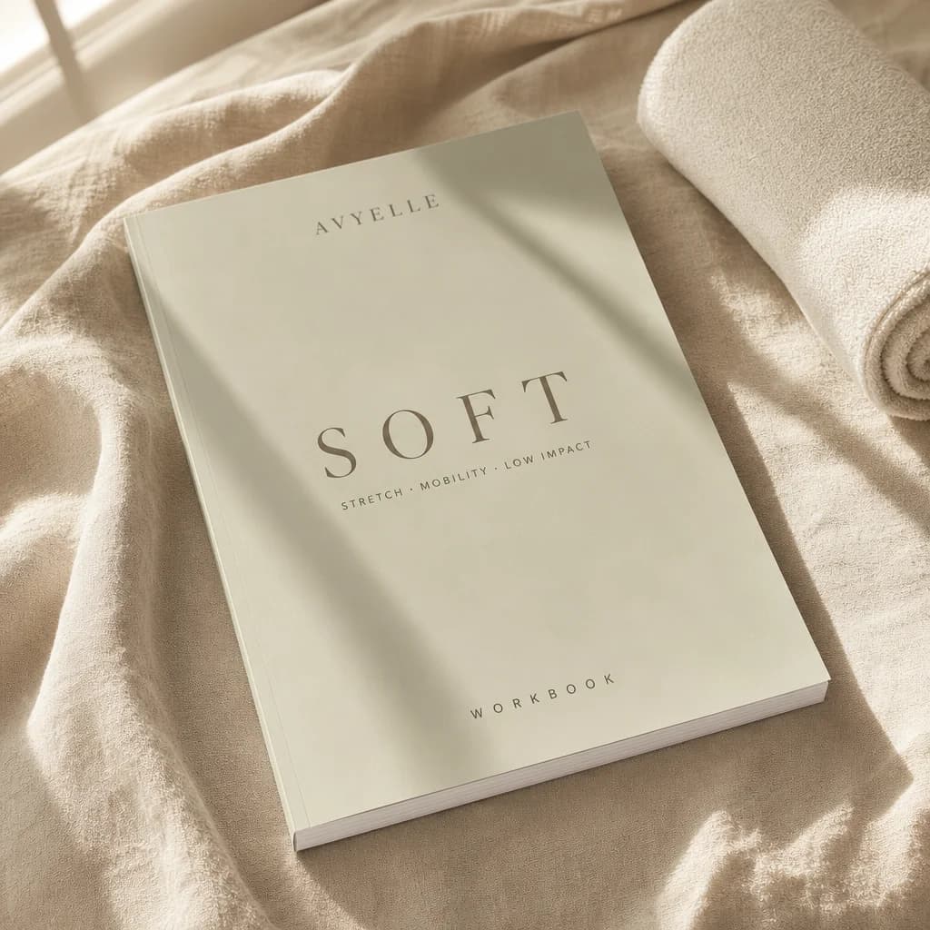 Printed workbook for SOFT, the Avyelle gentle stretch and mobility Pilates course, photographed in warm daylight